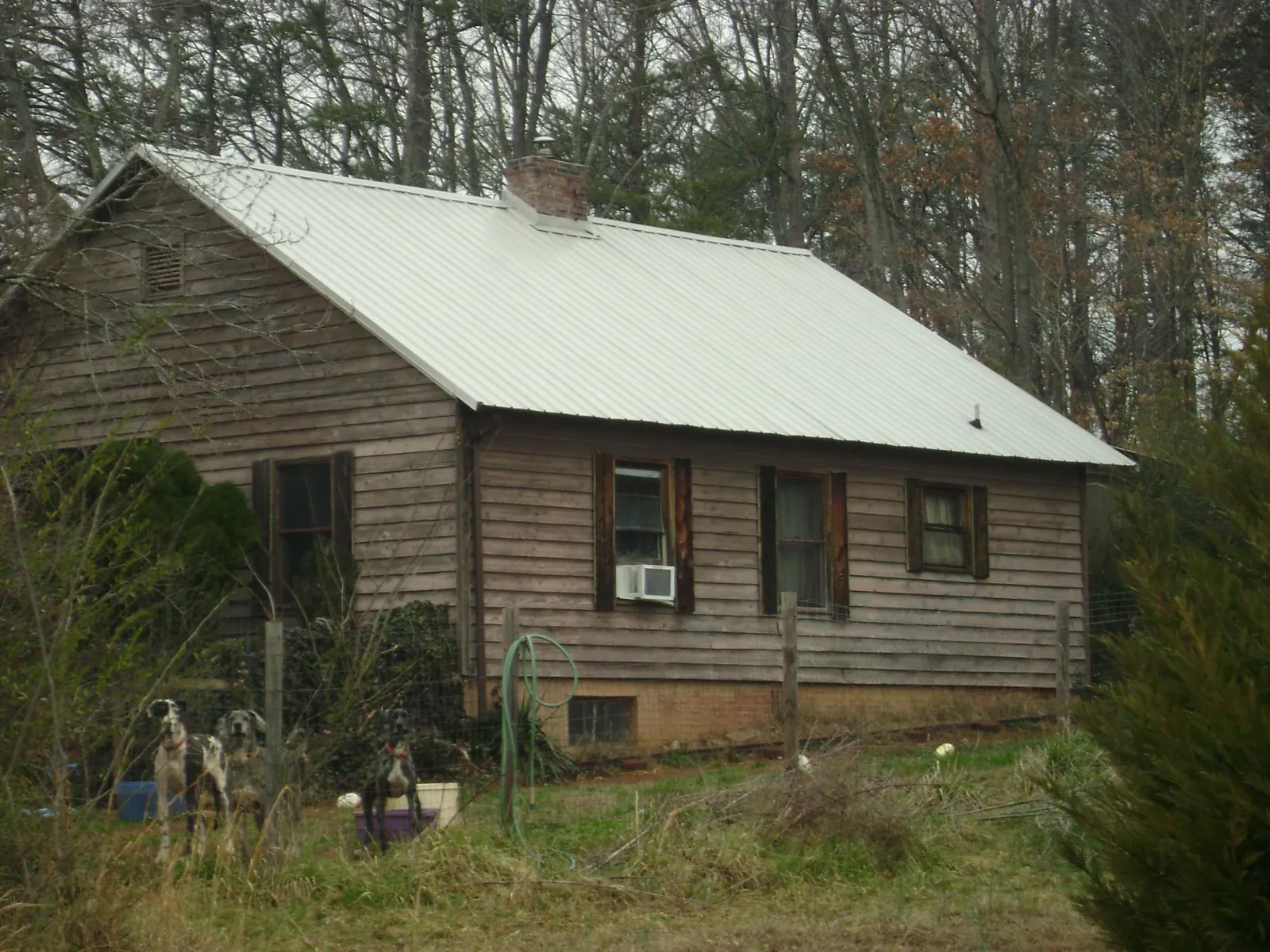 White metal roof on an old wood sided farmhouse, from a Metal Roof Installation job in North Newton
